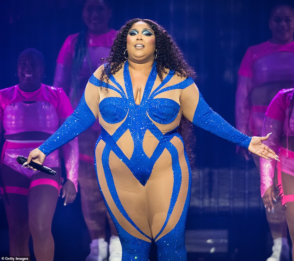 Sparkling: The singer, 34, hit the stage in a sparkling blue ɴuᴅᴇ illusion jumpsuit that clung to her curvaceous figure