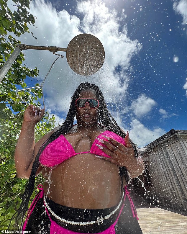 Chart-topper: Lizzo, 34, celebrated her second number one song by sharing a series of snaps of herself in a H๏τ pink ʙικιɴι and fishnet stockings combo