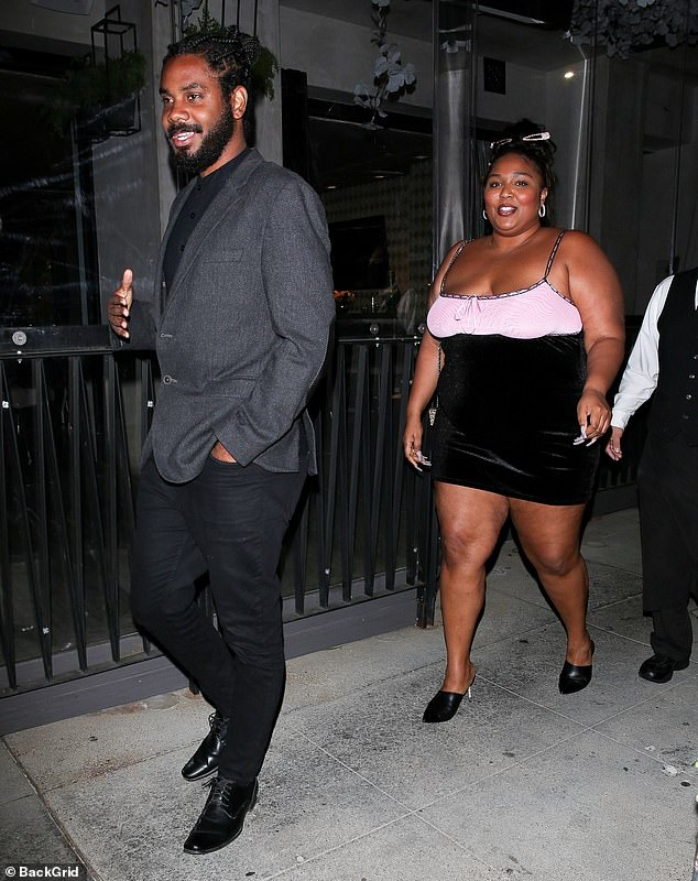 Out on the town: Lizzo, 33, beamed ear-to-ear as she stepped out with a mystery man she's previously been with during a dinner date at Crustacean in Beverly Hills on Wednesday