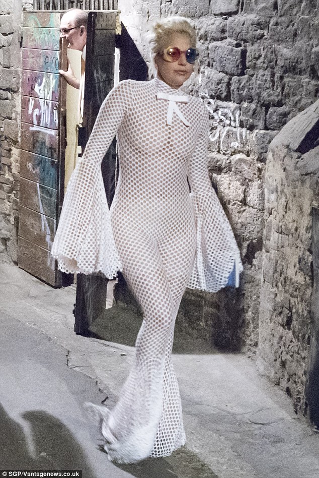 Making a statement: Lady Gaga went braless in a see-through netted white jumpsuit in Perugia, Italy on Monday