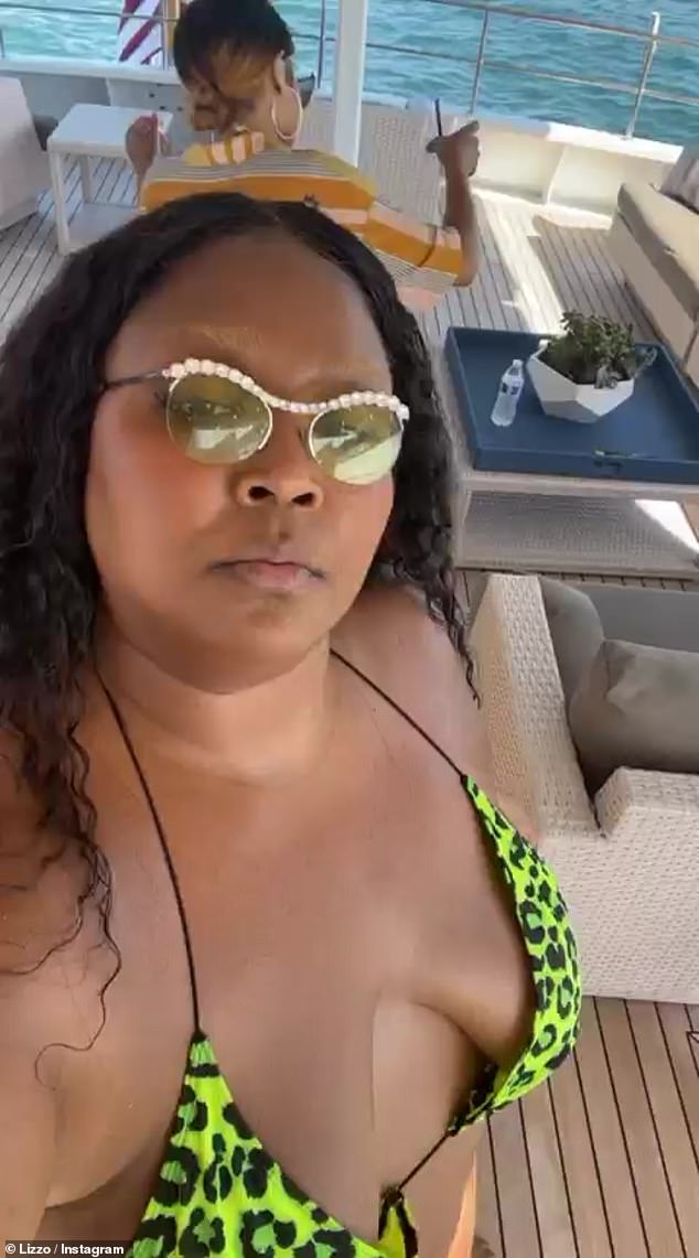 Celebrate good times! Lizzo, 33, celebrated the 4th Of July holiday in style by partying it up with friends in a yellow animal-print ʙικιɴι onboard a yacht on Sunday