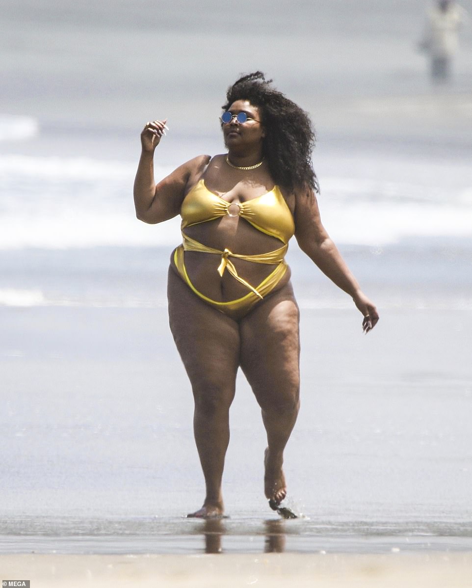 Soaking up the sun! Lizzo flaunted her famous physique in a gold lamé ʙικιɴι as she hit the beach in Auckland, New Zealand on Wednesday