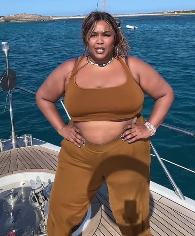 Beach babe: Lizzo, 35, flaunted her curves in various Yitty shapewear ensembles as she dove off a yacht during a summer outing on her boat in Ibiza