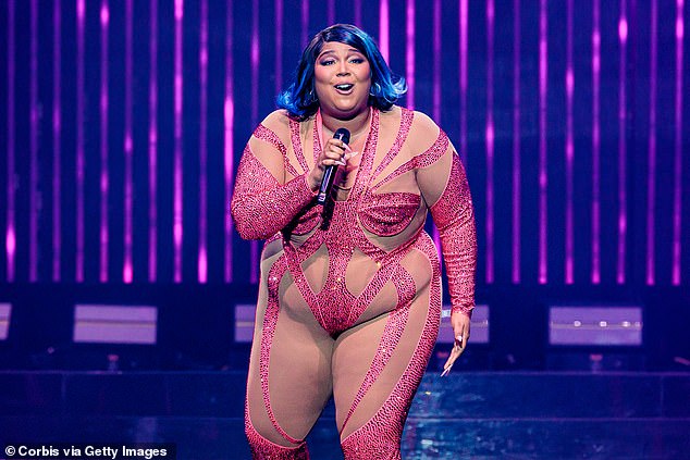 Unreal: The About Damn Time hitmaker looked incredible in a form-fitting one-piece, with H๏τ pink panels and dazzling rhinestones throughout