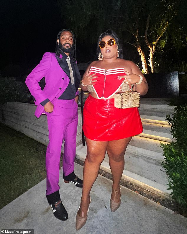 Her man: The musician and rapper also posed alongside her beau Myke Wright, who showed off his fashion sense in a purple suit with black lapels