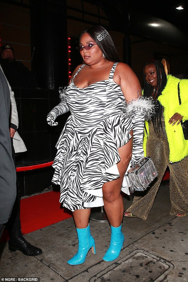 Party time: Lizzo bares her thighs in a provocative zebra print Miscreants, London dress as she hosts a strip club Grammys afterparty