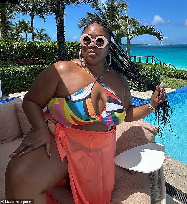 Stunning: On Friday, Lizzo, 34, took to Instagram to show off a series of pH๏τos of herself sporting a colorful, geometric one-piece swimming suit as she enjoyed a tropical getaway