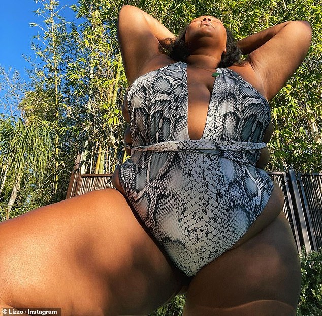 Snake in the grᴀss: Lizzo put on a sizzling display Sunday in a plunging white snakeskin one-piece, as she flaunted her gorgeous curves, taking to Instagram with an impromptu backyard pH๏τoshoot