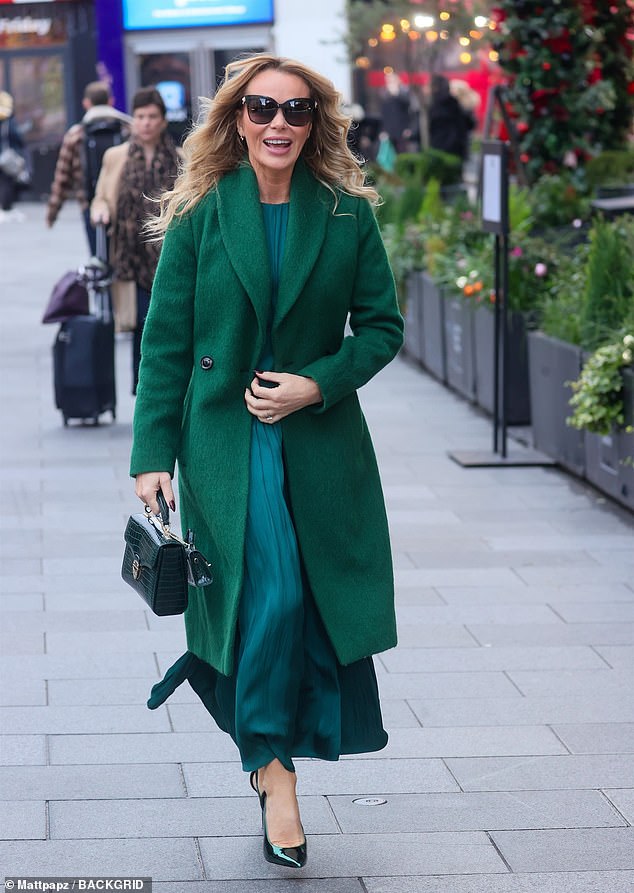 Amanda Holden looked chic as ever in an emerald green dress and matching trench coat as she left Heart Radio FM studios on Thursday