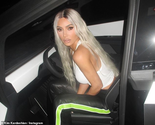 Kim Kardashian had a creepy interaction with Elon Musk's ,000 Tesla bot in a video shared to Instagram on Monday - pictured in her Tesla Cybertruck