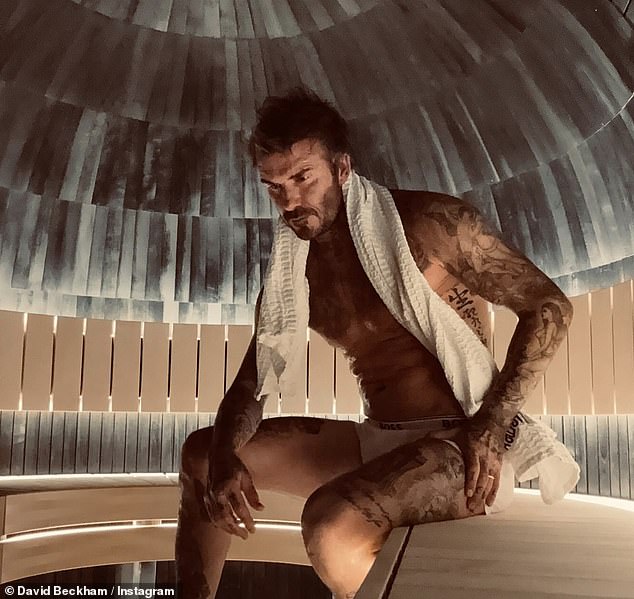 David Beckham, 49, showed off his ageless physique as he posed shirtless for a snap in the sauna on Friday