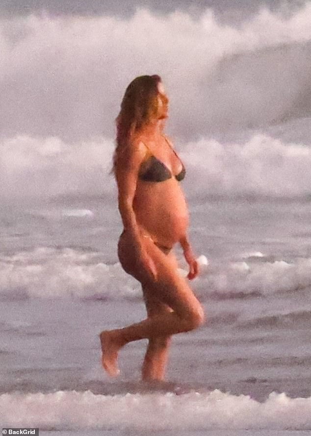 Gisele Bundchen put her baby bump on display as she enjoyed a beach day with her boyfriend Joaquim Valente and family on Christmas Eve