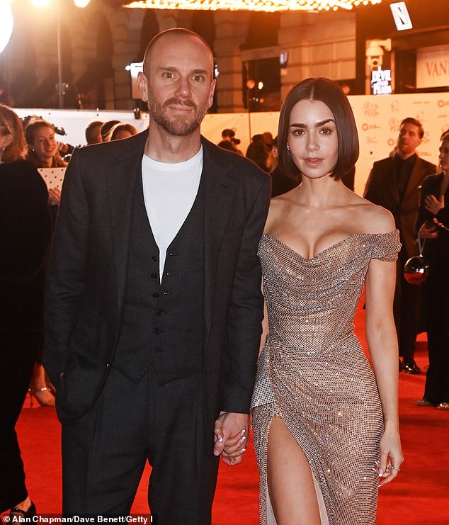 Lily Collins cut a typically stylish figure in a glamorous gold gown as she at The Devil Wears Prada: The Musical premiere on Sunday night her husband Charlie McDowell